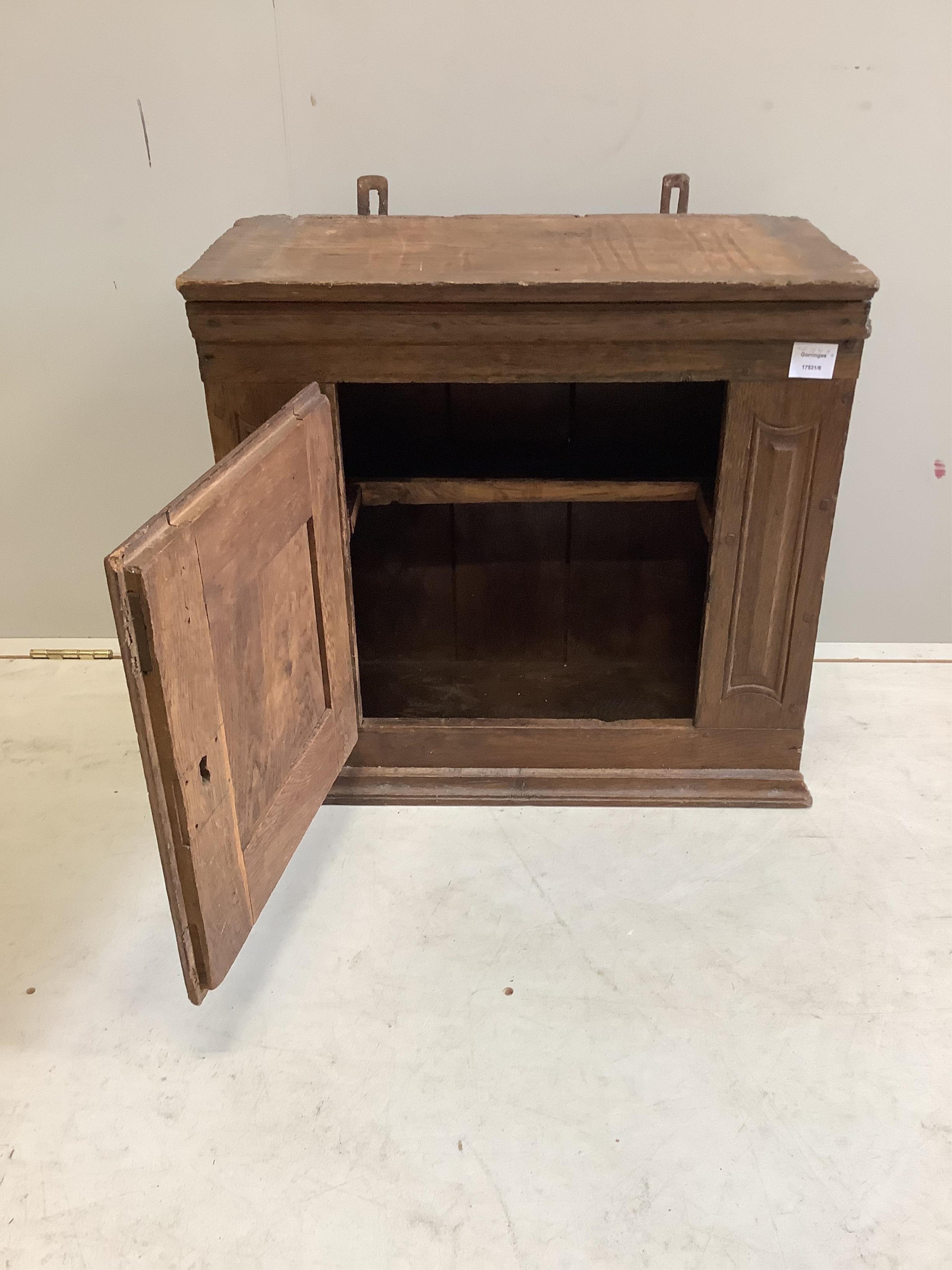 A small oak cupboard, width 61cm, depth 32cm, height 58cm